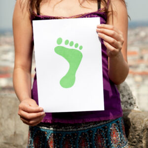 Woman holding paper green foot